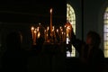 People light candles during festive prayer in church Royalty Free Stock Photo